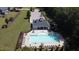Aerial view of pool, lounge chairs, playground, and parking at 125 Durban Meadow Dr, Holly Springs, NC 27540