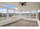 Bright sunroom with large windows and gray wood floor, ideal for relaxing and enjoying natural light at 125 Durban Meadow Dr, Holly Springs, NC 27540
