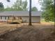 Backyard featuring a newly built deck, gray vinyl siding, and fenced yard with mature trees at 125 Tast Dr, Wendell, NC 27591