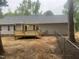 Backyard featuring a newly built deck, gray vinyl siding, and fenced yard with mature trees at 125 Tast Dr, Wendell, NC 27591