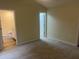 Spacious bedroom with neutral carpet and trim, plus a view into the connected bathroom at 125 Tast Dr, Wendell, NC 27591