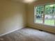 Bedroom with a large window providing natural light and outdoor views at 125 Tast Dr, Wendell, NC 27591