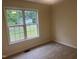 Well-lit bedroom featuring a large window with views of the neighborhood at 125 Tast Dr, Wendell, NC 27591