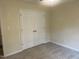 Bedroom featuring neutral carpet, freshly painted walls, and double door closet at 125 Tast Dr, Wendell, NC 27591