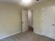 View of carpeted bedroom with open door and closet at 125 Tast Dr, Wendell, NC 27591