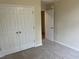 A cozy bedroom with plush carpeting, large closet doors, and neutral wall colors at 125 Tast Dr, Wendell, NC 27591