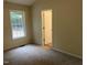 A bedroom shows new carpet, a window, and natural light at 125 Tast Dr, Wendell, NC 27591
