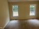 A bedroom with carpet, two windows, and natural light at 125 Tast Dr, Wendell, NC 27591