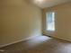 A bedroom features neutral colors, new carpet, and a window with natural light at 125 Tast Dr, Wendell, NC 27591