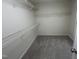 Walk-in closet featuring metal shelves and neutral carpet at 125 Tast Dr, Wendell, NC 27591