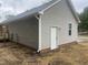 Exterior of the home featuring gray vinyl siding, red brick facade and back door access to the fenced yard at 125 Tast Dr, Wendell, NC 27591