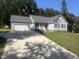 Charming single-story home with a two-car garage and a well-manicured front lawn at 125 Tast Dr, Wendell, NC 27591