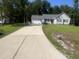 Charming single-story home with a two-car garage and a well-manicured front lawn at 125 Tast Dr, Wendell, NC 27591