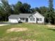 Charming single-story home with a two-car garage, blue shutters, and a cozy front porch at 125 Tast Dr, Wendell, NC 27591