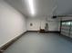 An interior view of a clean and well lit garage with a freshly painted floor at 125 Tast Dr, Wendell, NC 27591