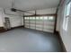 This is an interior shot of a spacious garage with a door and windows at 125 Tast Dr, Wendell, NC 27591