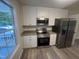 A modern kitchen features white cabinets, stainless steel appliances, and granite countertops at 125 Tast Dr, Wendell, NC 27591