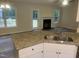 An open-concept kitchen features a stainless steel faucet and granite countertops at 125 Tast Dr, Wendell, NC 27591