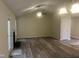 Open-concept living room and dining room with wood flooring and a ceiling fan at 125 Tast Dr, Wendell, NC 27591