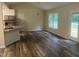Open-concept kitchen and dining room with wood flooring and deck access, and stainless-steel appliances at 125 Tast Dr, Wendell, NC 27591