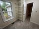 Walk-in closet featuring wire shelving, neutral carpet, and a window at 125 Tast Dr, Wendell, NC 27591
