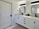 Modern bathroom with dual sinks, marble countertops, sleek fixtures, and abundant storage; stylish space at 129 Grande Dr, Morrisville, NC 27560
