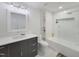 Modern bathroom featuring white tile, updated vanity, and recessed lighting at 129 Grande Dr, Morrisville, NC 27560