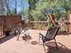 Relaxing backyard deck with chairs and a small table, surrounded by lush greenery at 129 Grande Dr, Morrisville, NC 27560