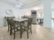 Open concept dining room with modern chandelier lighting fixture, table, and seating near living space at 129 Grande Dr, Morrisville, NC 27560