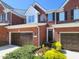 Inviting brick townhouse with a two-car garage and well-maintained landscaping at 129 Grande Dr, Morrisville, NC 27560