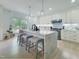 Spacious kitchen featuring a large marble island, white cabinetry, and stainless steel appliances at 129 Grande Dr, Morrisville, NC 27560