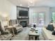 Inviting living room with cozy fireplace, comfortable seating, and natural light at 129 Grande Dr, Morrisville, NC 27560