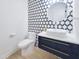 Stylish powder room with designer wallpaper, modern vanity, vessel sink, and sleek gold accents at 129 Grande Dr, Morrisville, NC 27560