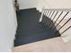 Staircase with elegant wood steps and white railing; transitional decor to the upper level at 129 Grande Dr, Morrisville, NC 27560