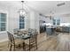 Elegant dining room with a modern light fixture, seating for six and an open-concept design at 1534 Millrock Trl, Wendell, NC 27591