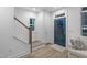 Bright entryway with modern staircase, blue front door and wood-look floors for a welcoming feel at 1534 Millrock Trl, Wendell, NC 27591