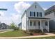 Corner view of a two-story home with well-manicured lawn and tidy landscaping along the sidewalk at 1534 Millrock Trl, Wendell, NC 27591