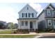 Charming two-story home with light blue siding, black shutters, and a welcoming front porch at 1534 Millrock Trl, Wendell, NC 27591