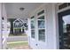 Close-up of the front porch showcasing the view, white trim, and the stylish blue front door at 1534 Millrock Trl, Wendell, NC 27591