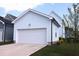 Detached garage with a white garage door and concrete driveway, with green grass at 1534 Millrock Trl, Wendell, NC 27591