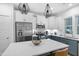 Stylish kitchen with stainless steel appliances, white cabinets, and a spacious island for cooking and gathering at 1534 Millrock Trl, Wendell, NC 27591