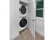 This closet laundry room features a stacked washer and dryer set with a window to the right at 1534 Millrock Trl, Wendell, NC 27591