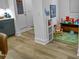 This playroom features wood-look floors, a storage unit with fabric drawers, and a play area with toys at 1534 Millrock Trl, Wendell, NC 27591