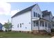 View of the rear of the house, showcasing the light blue siding and well-kept green grass at 1534 Millrock Trl, Wendell, NC 27591