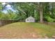 Lush backyard features a detached garage and bordered by a wood fence at 1826 Northgate St, Durham, NC 27704