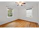 Cozy bedroom featuring hardwood floors and natural light from two windows at 1826 Northgate St, Durham, NC 27704
