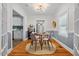 Charming dining room features a glass top table and 4 modern chairs set on a sisal rug at 1826 Northgate St, Durham, NC 27704