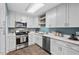 Bright kitchen with white cabinets, stainless appliances, and light countertops at 1826 Northgate St, Durham, NC 27704