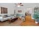 Bright living room featuring beautiful hardwood floors and stylish decor open to dining room at 1826 Northgate St, Durham, NC 27704