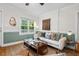 Stylish living room with hardwood floors and plenty of natural light from a large window at 1826 Northgate St, Durham, NC 27704